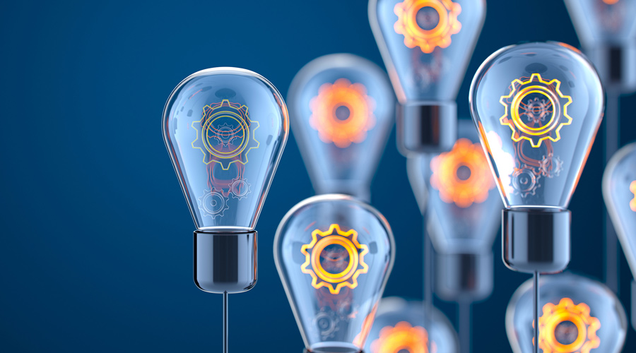 Photo of lightbulbs with gears inside on dark blue gradient background