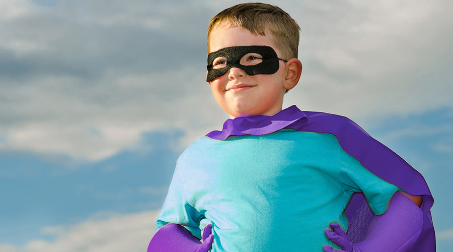 Photo of a little boy wearing a super hero costume